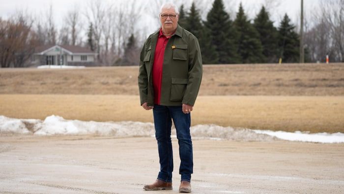 Mr. Poirier stands in a parking lot.