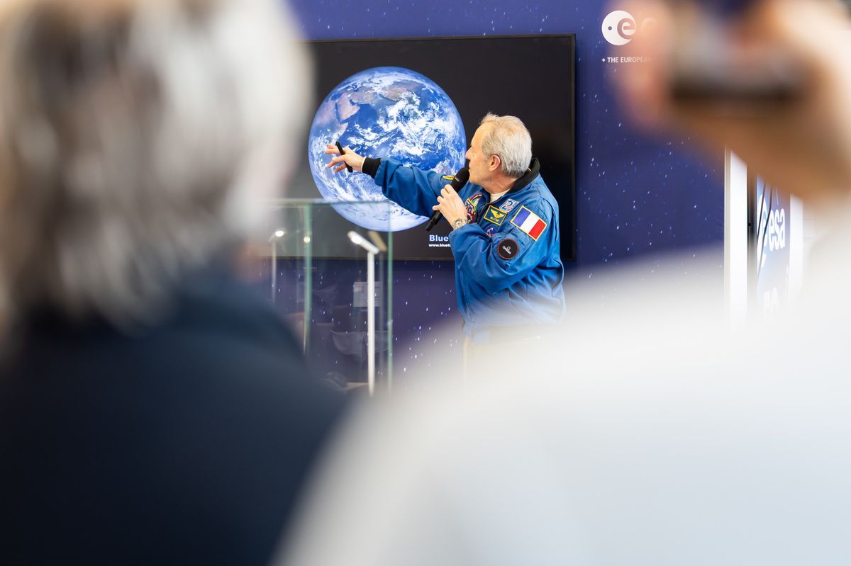 Conference at the International Inventions Show in Geneva with a speaker showing an image of the land. Conference at the International Inventions Show in Geneva with a speaker showing an image of the land.
