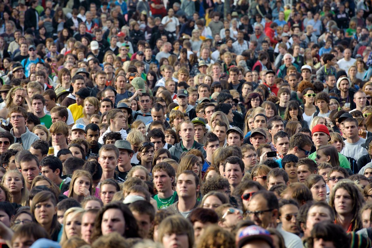 Dense crowd of people waiting for a concert at the Paleo Festival on July 22, 2001, illustrating the theme of global population growth. Dense crowd of people waiting for a concert at the Paleo Festival on July 22, 2001, illustrating the theme of global population growth.