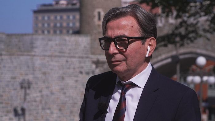 Serge Flyfel gives an interview with Radio-Canada outside.