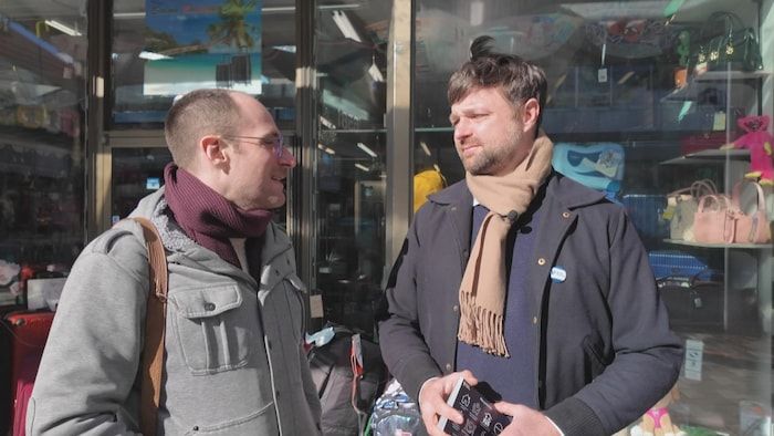 Two men discuss.