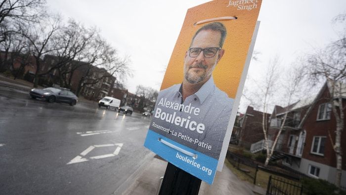 A poster is hung on a post.