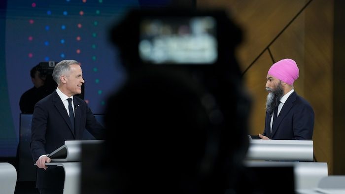Liberal leader Mark Carney, on the left, and the leader of the new democratic party Jagmeet Singh