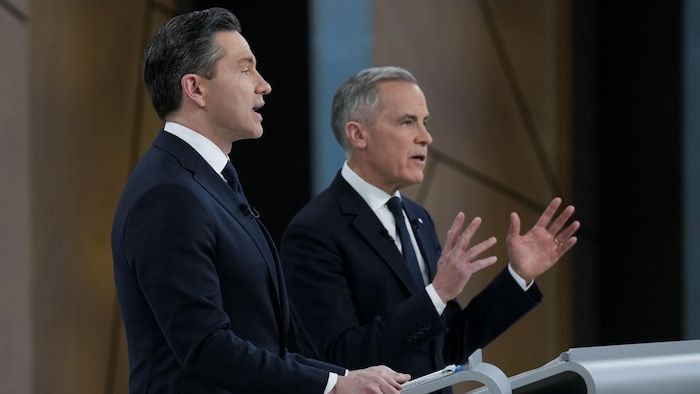 The two men speak on the set of the debate.