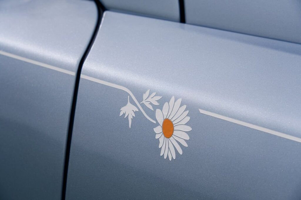 A subtle powdery blue exterior painting, embellished with a Marguerite pattern that adorns the coachline - © Rolls -Royce