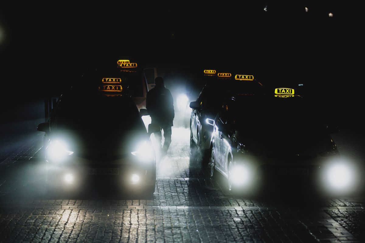 Silhouette of a man between taxis at night in Berlin, January 17, 2025. Silhouette of a man between taxis at night in Berlin, January 17, 2025.
