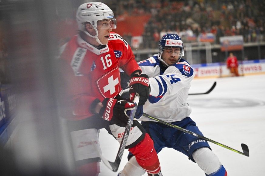 Switzerland's Dario Wuethrich, left, and Slovakia's Andrej Krajcovic in action during the friendly icehockey game between Switzerland and Slovakia at the Sportzentrum Arena in Herisau, Switz ...