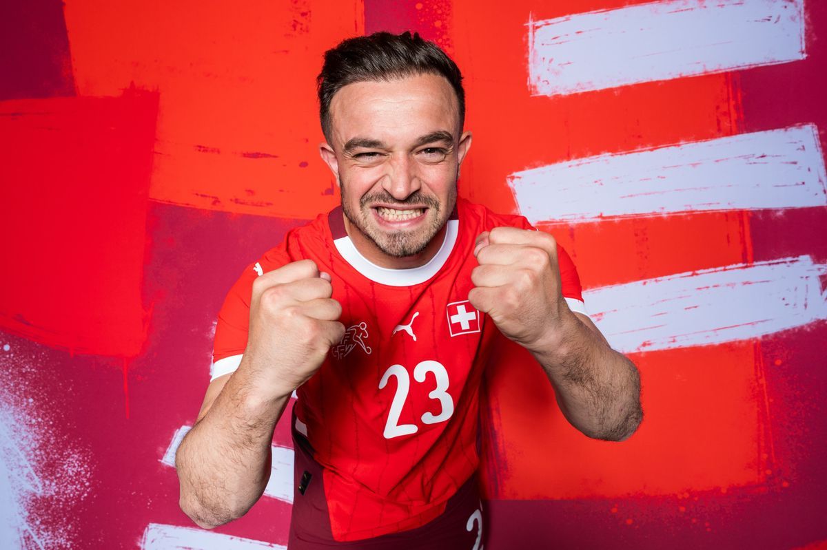 Xherdan Shaqiri, Swiss player, pose in red jersey number 23, smiling with tight fists, in front of a red background, in Stuttgart before Euro 2024. Xherdan Shaqiri, Swiss player, pose in red jersey number 23, smiling with tight fists, in front of a red background, in Stuttgart before Euro 2024.