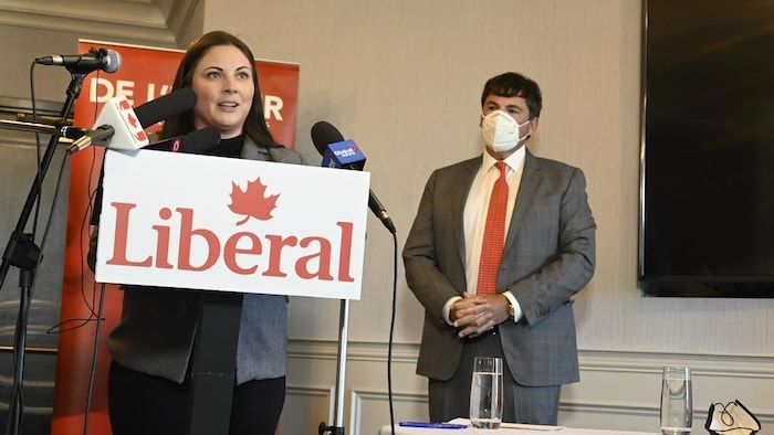 A man and a woman at a press conference.
