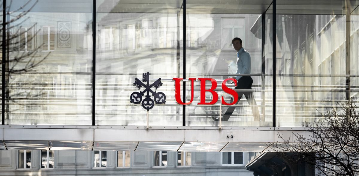Silhouette of an employee next to the UBS and Credit Switzerland brands in Zurich, March 20, 2023, when the Credit Suisse is announced by UBS. Silhouette of an employee next to the UBS and Credit Switzerland brands in Zurich, March 20, 2023, when the Credit Suisse is announced by UBS.