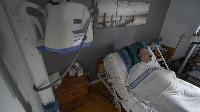 A quadriplegic in a bed.