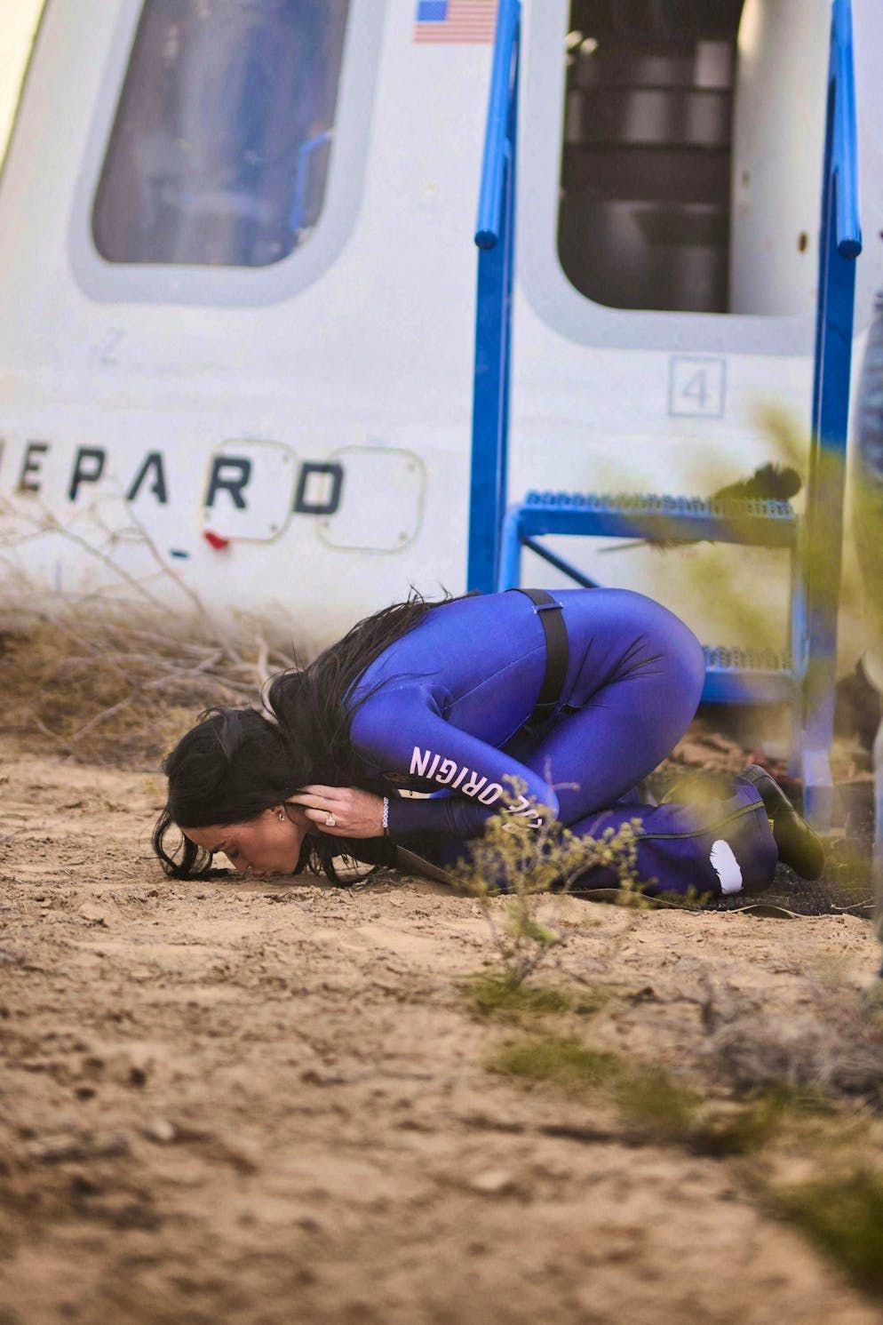 Katy Perry kisses the ground after a brief flight in space.