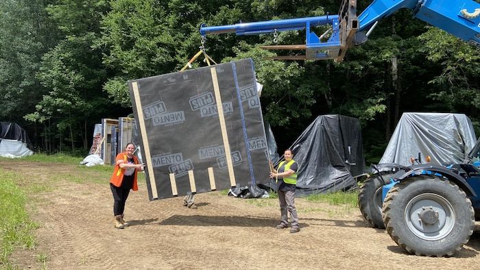Aboriginal women assembling modular panels on the construction site.