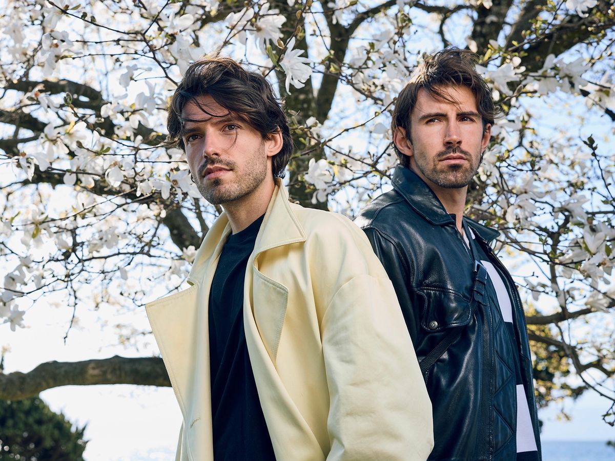 Benjamin Bühler and Evan Giusto, creators of the Evanbenjamin brand, pose under a flower tree in Morges. Photo by Yvain Genevay. Benjamin Bühler and Evan Giusto, creators of the Evanbenjamin brand, pose under a flower tree in Morges. Photo by Yvain Genevay.