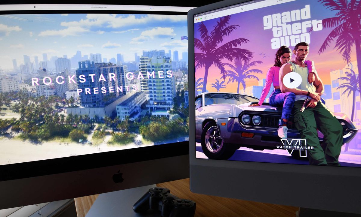Two computer screens display the Grand Theft Auto 6 trailer by Rockstar Games, illustrating a city scene and a character sitting on a car in Los Angeles on December 5, 2023. Two computer screens display the Grand Theft Auto 6 trailer by Rockstar Games, illustrating a city scene and a character sitting on a car in Los Angeles on December 5, 2023.
