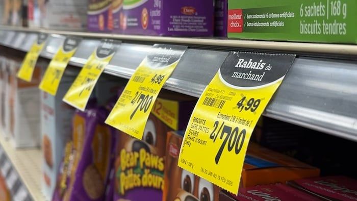 Several price labels at a discount in a grocery store.