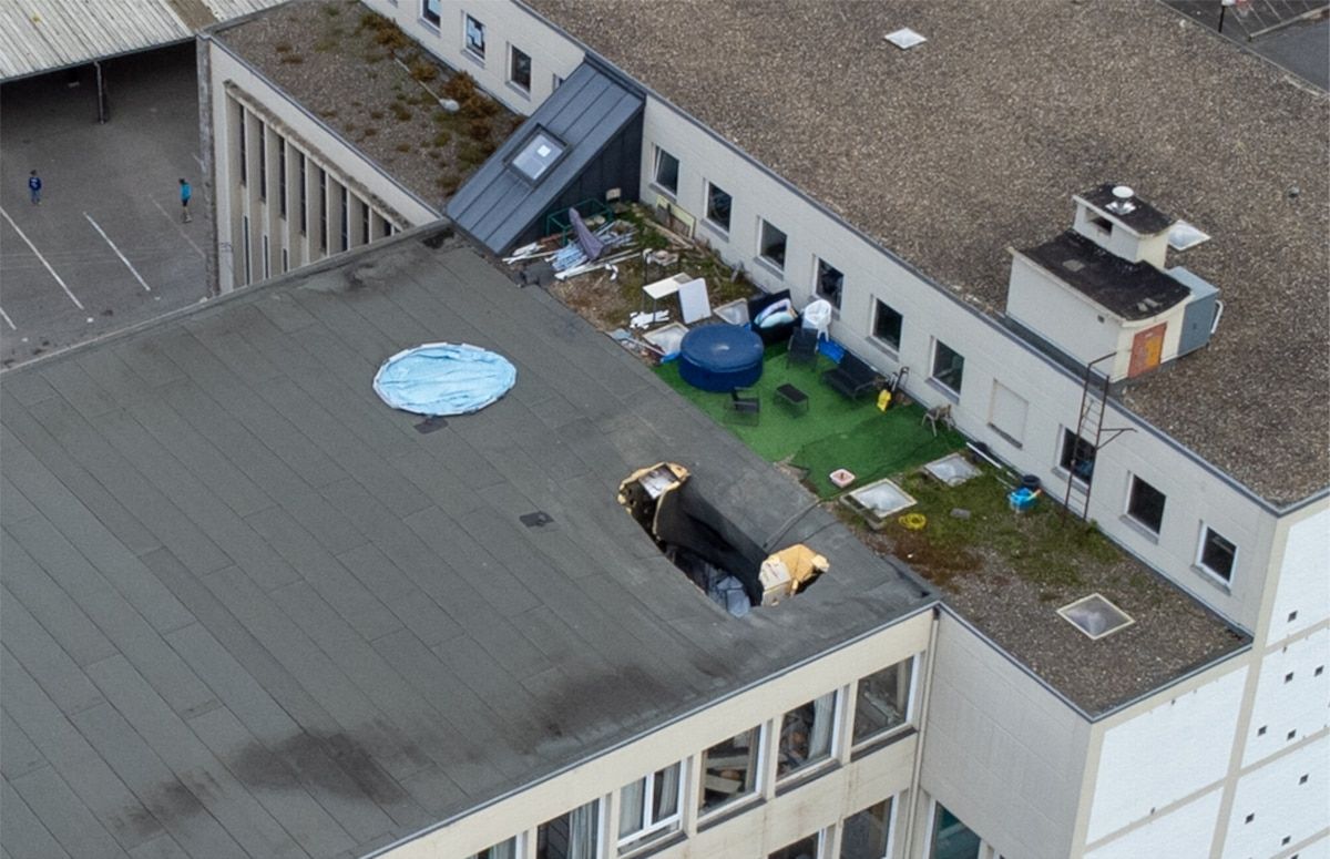 On the school roof, a gaping hole in the area of a class.