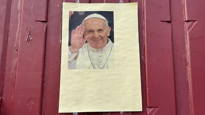 A poster showing Pope Francis on the Saint-Charles church in Blanc-Mesnil, in the suburbs of Paris.