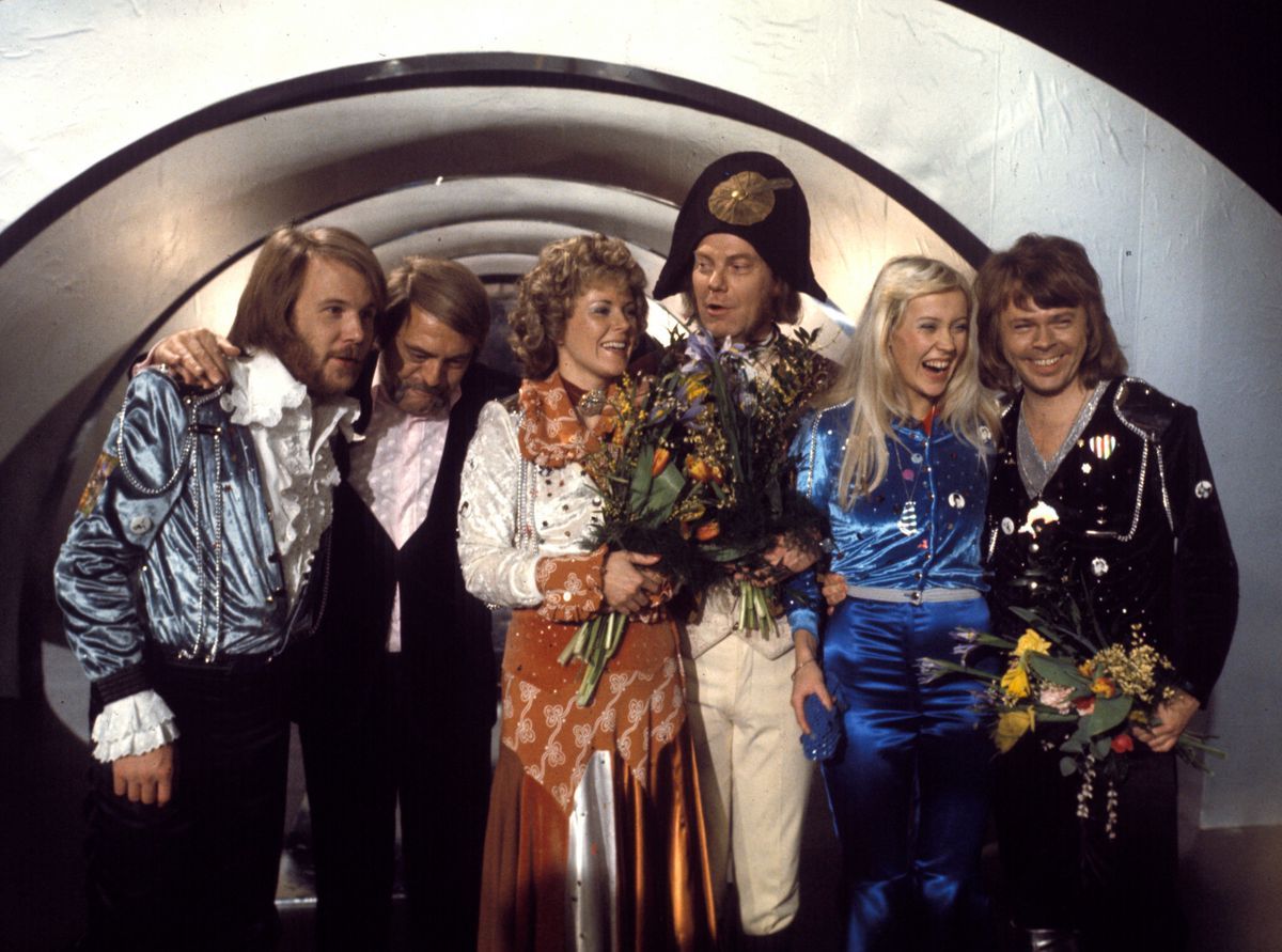 Swedish pop group Abba celebrating their victory for the Swedish qualifications of Eurovision with 'Waterloo' in Stockholm, 1974, surrounded by their manager and the conductor, holding bouquets of flowers. Swedish pop group Abba celebrating their victory for the Swedish qualifications of Eurovision with 'Waterloo' in Stockholm, 1974, surrounded by their manager and the conductor, holding bouquets of flowers.