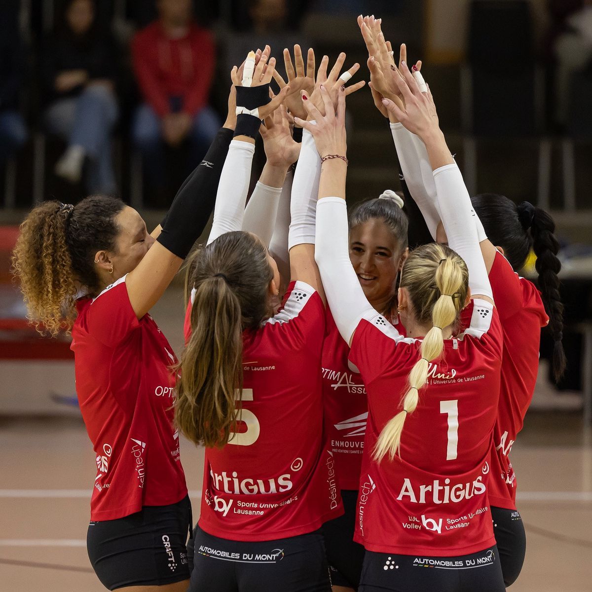 Red volleyball players congratulate themselves in the center of an indoors. Red volleyball players congratulate themselves in the center of an indoors.