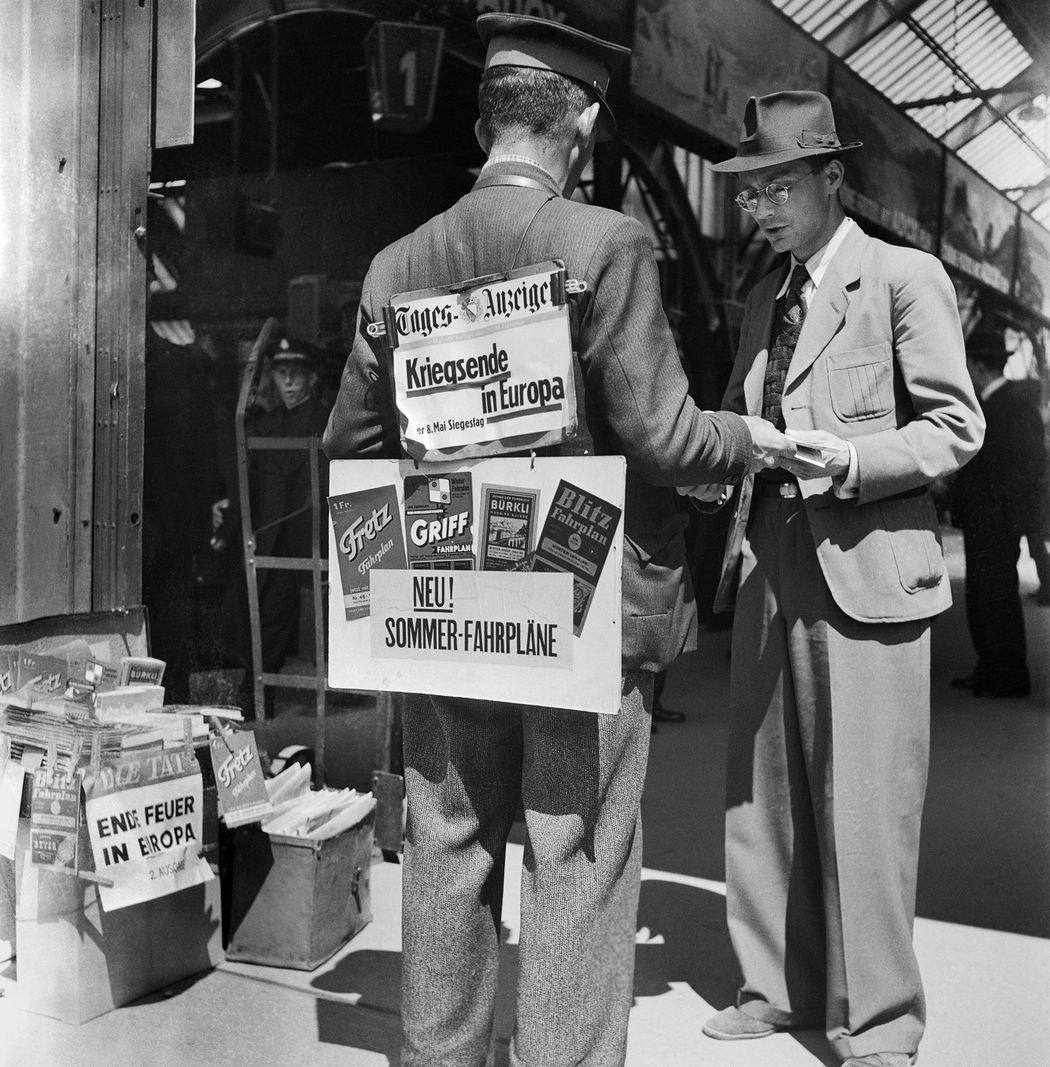 A newspaper seller at the train station in Zurich, Switzerland, sells newspapers such as the 'Daily Anzeiger' on May 8, 1945, the day of the end of the war in Europe. A newspaper seller at the train station in Zurich, Switzerland, sells newspapers such as the 'Daily Anzeiger' on May 8, 1945, the day of the end of the war in Europe.