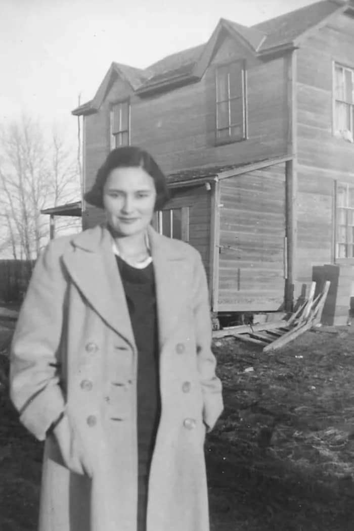 Marion Ironquil Meadmore in front of her childhood house, in Saskatchewan.