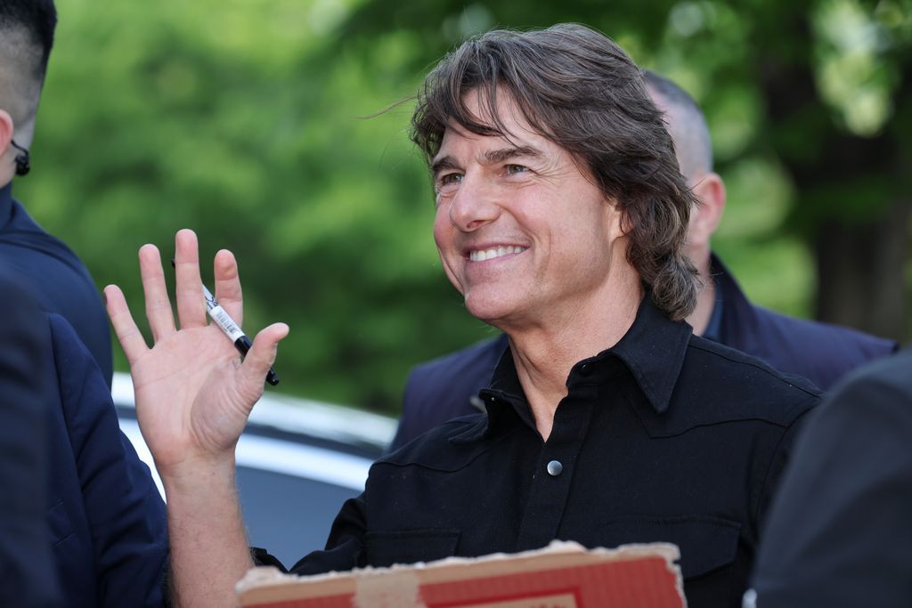 Tom Cruise waves to his fans upon his arrival at Gimpo Airport in Seoul, South Korea.