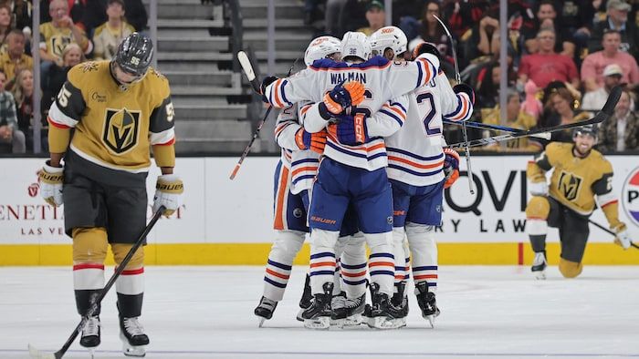 Jake Wallman's teammates congratulate him after a goal.
