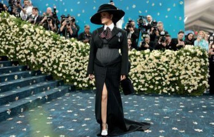 She reveals her round belly at Met Gala