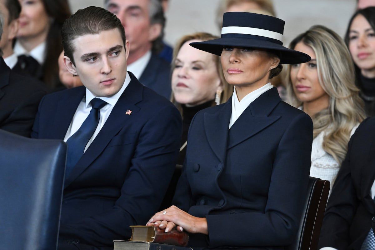 Barron Trump and First Lady Melania Trump listen to Donald Trump deliver his speech.