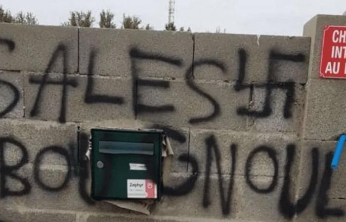 racist tags and swastikas written on the walls of a mosque