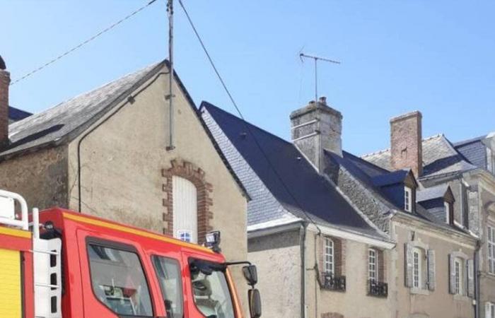 A fire is underway on the roof of an outbuilding in the town centre of Évron