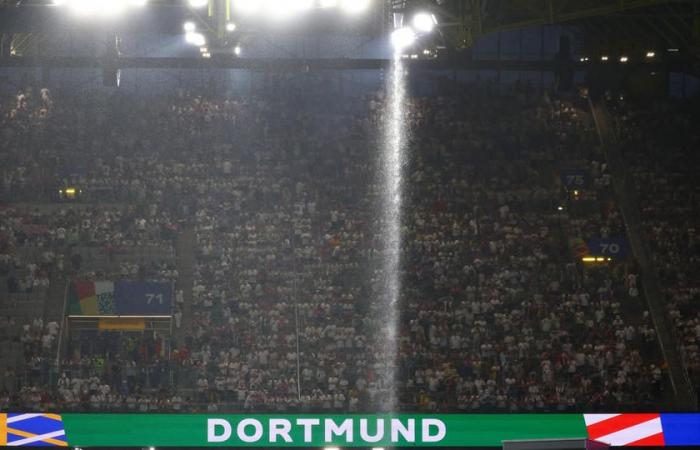 a hooded individual arrested on the roof of the Dortmund stadium after Germany-Denmark
