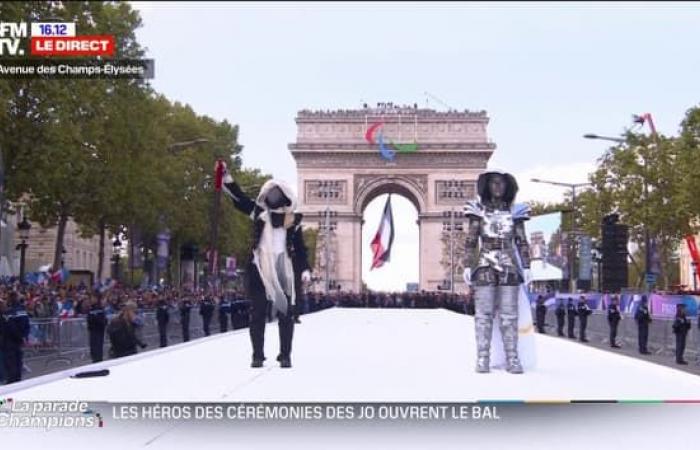 The
      rider
      and
      the
      masked
      torchbearer
      return
      for
      the
      parade
      of
      champions