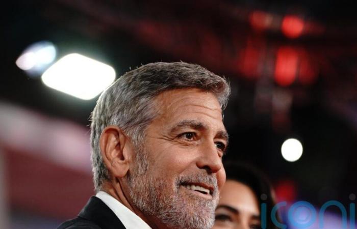 George Clooney plays photographer at star-studded charity event