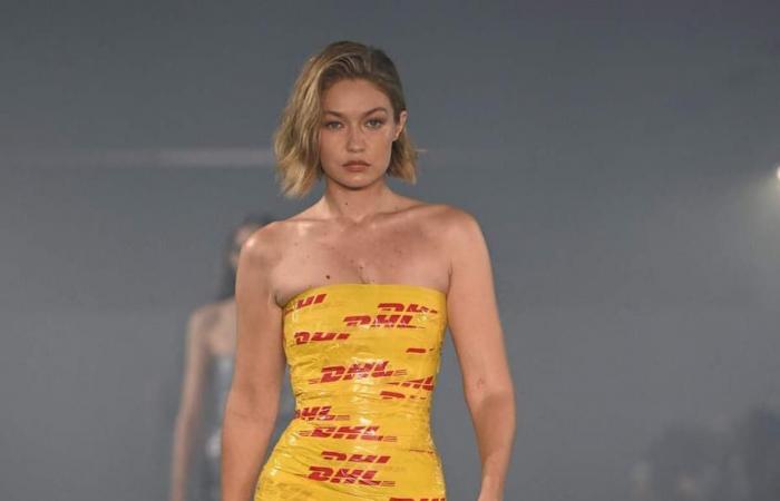 Gigi Hadid walks the runway in a dress made with DHL delivery tape at Paris Fashion Week and we have all the photos for you