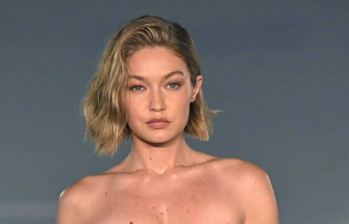 Gigi Hadid walks the runway in a dress made with DHL delivery tape at Paris Fashion Week and we have all the photos for you