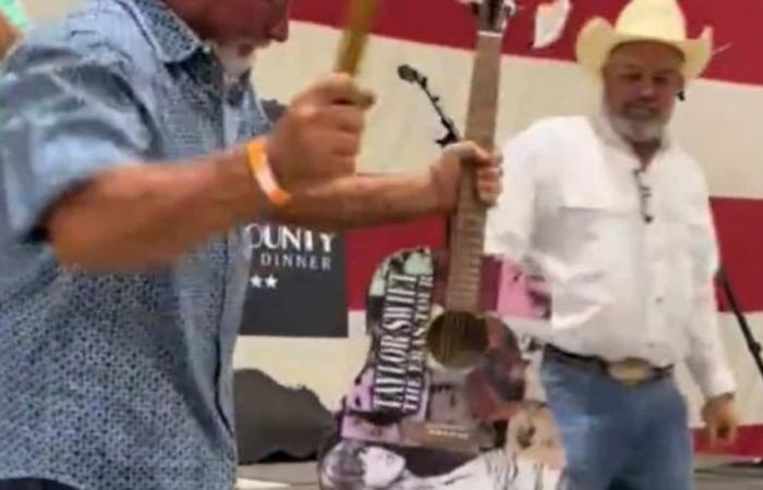 He buys a guitar signed by Taylor Swift for $5,000 before destroying it with a hammer