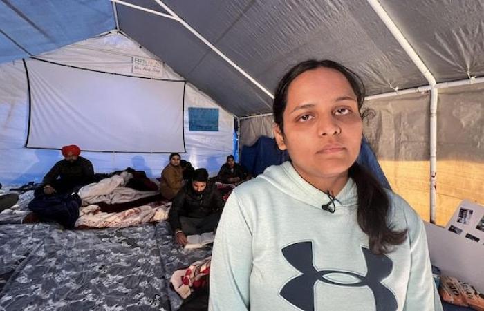 Unable to obtain permanent residency, they camp along a highway