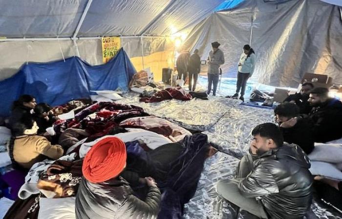 Unable to obtain permanent residency, they camp along a highway