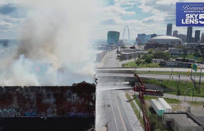 Historic warehouse catches fire weeks after owner sought police protection from homeless trespassers; billowing smoke shutters Stan Musial Bridge