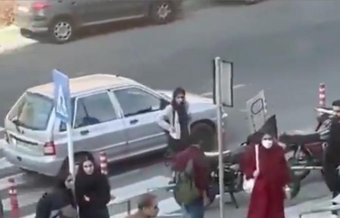 a student undresses in front of her university to protest against the moral police, before being arrested