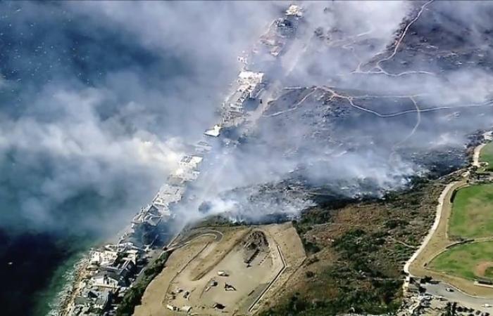 A large fire ravages the northwest suburbs of Los Angeles, another threatens the upscale city of Malibu