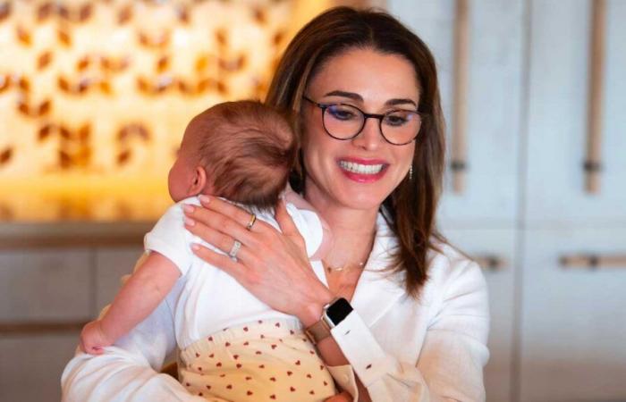 Queen Rania teleworks with her granddaughter Iman in her arms