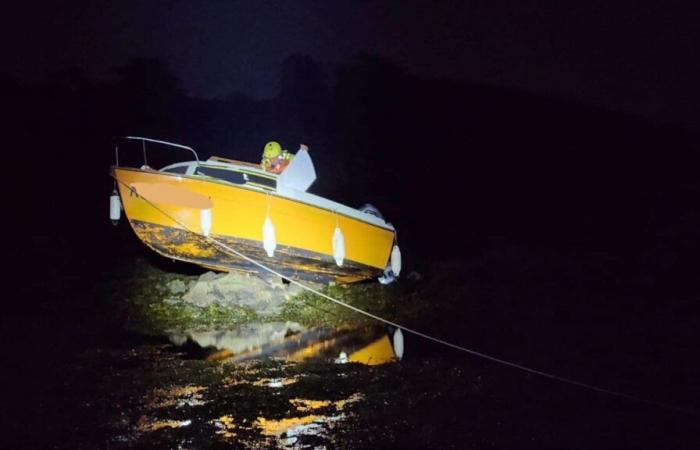 A beached boat and a woman stranded by the tide in the Gulf of Morbihan