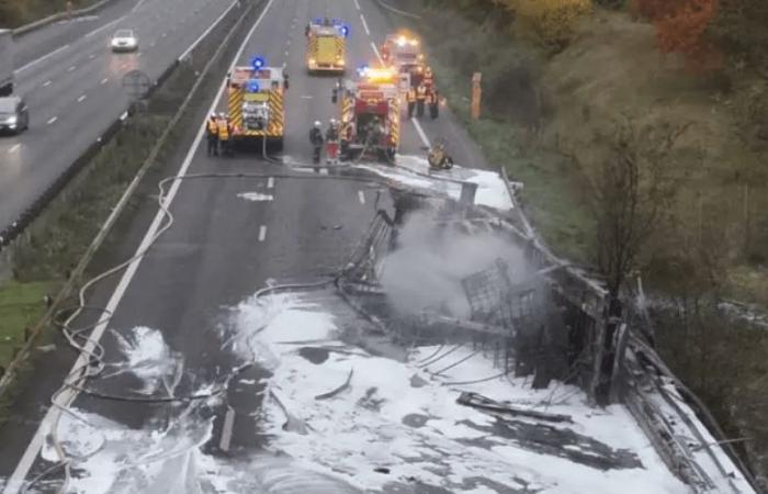 a police officer and a gendarme extricate a driver before his truck explodes