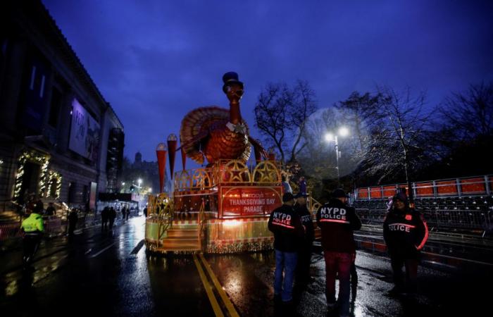 In steady rain a century after its first trip through NYC, the Macy’s Thanksgiving Day Parade kicks off