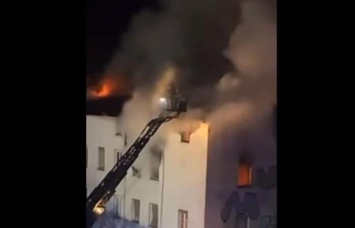 two people defend themselves from a window to escape from a burning squat known for its dilapidation