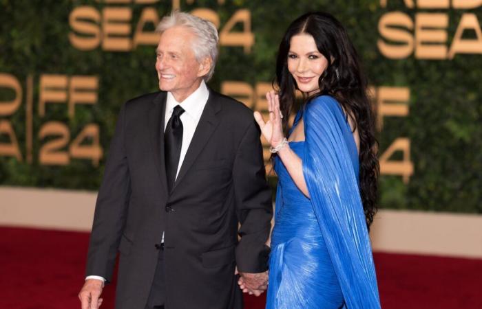 On the arm of Michael Douglas in Jeddah, Catherine Zeta-Jones turns heads in her azure cape dress