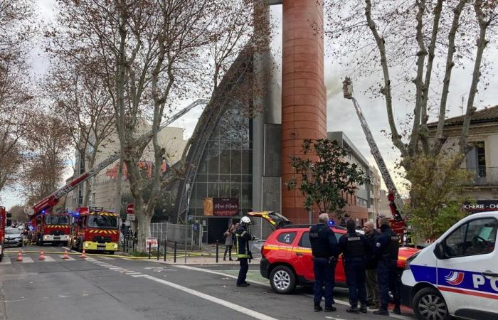 roof fire in progress at the Church of Saints Francis near the station, firefighters fight against the flames